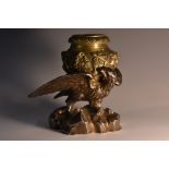 A 19th century novelty inkwell, cast with an eagle with wings outspread,