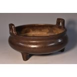 A Chinese bronze ding tripod censer, angular lug handles, 15cm diam,