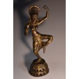 Indian School, a brown and gilt patinated bronze, of a dancing deity, pierced domed base,