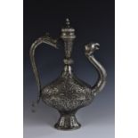 A large Islamic silvered wine ewer, profusely chased with stylised beasts,