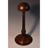 A George III mahogany wig stand, domed hemispherical rest, reeded and fluted support,