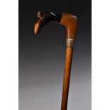 A silver mounted gentleman's novelty walking cane, the handle carved as a leg and boot,
