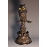 A 19th century Irish bog oak model, carved as an owl on a perch,