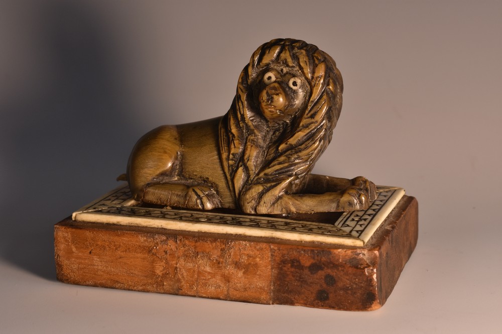 A 19th century Anglo-Indian horn carving, of a recumbent lion,