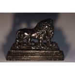 A 19th century cast iron door stop, as a lion, stepped rectangular base, 26cm wide, c.