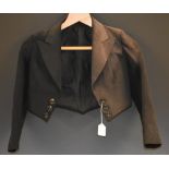 A Victorian boy's black jacket, outswept wing lapels, breasted each side, c.