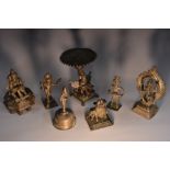 An Indian bronze puja lamp, lotus shaped pan above a deity, square base, 15.