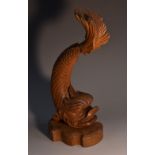 A 19th century hardwood carving, of a dolphin, in the Renaissance taste, shaped plinth base,