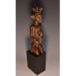 Tribal Art - an African hardwood fertility figure, of a female kneeling,