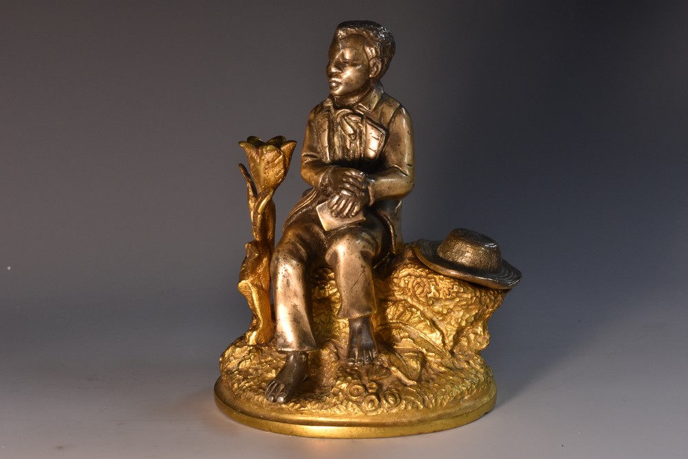 A 19th century gilt and silvered bronze novelty inkwell, cast as a young negro,