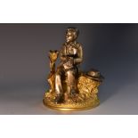 A 19th century gilt and silvered bronze novelty inkwell, cast as a young negro,