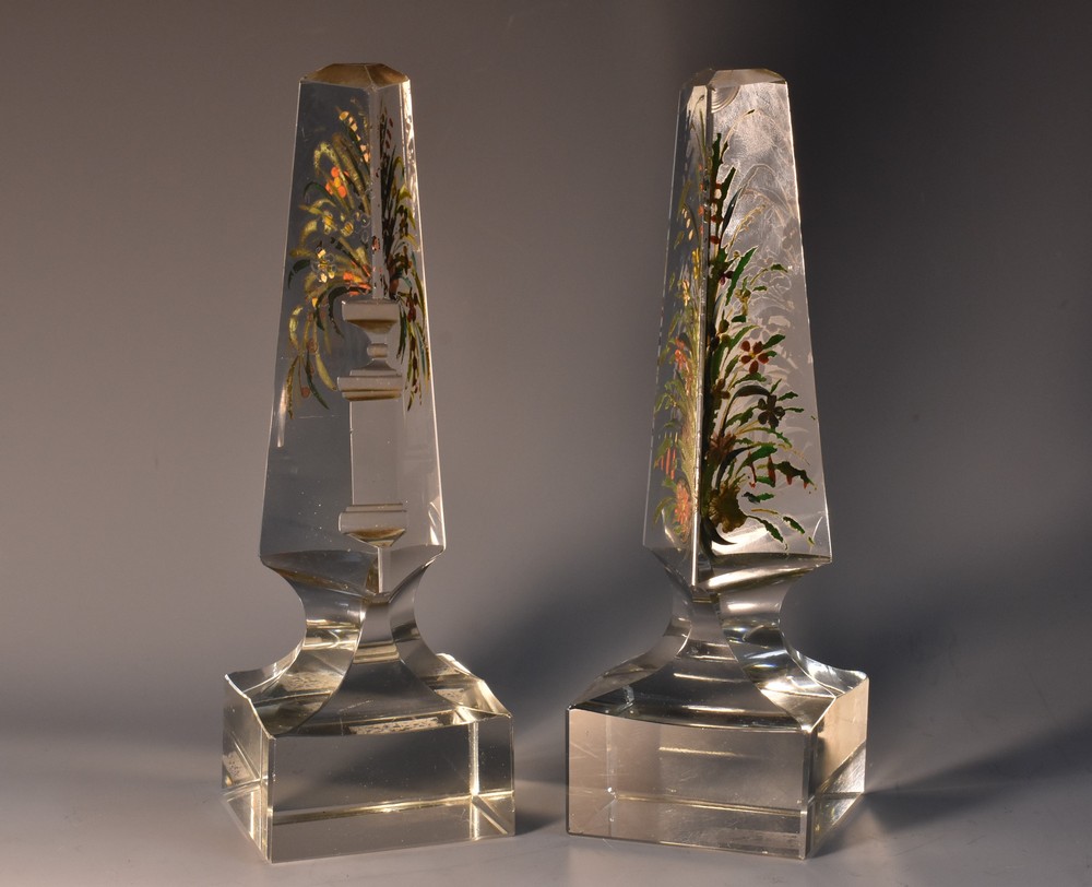 A matched pair of late 19th century cut glass triangular desk obelisks,
