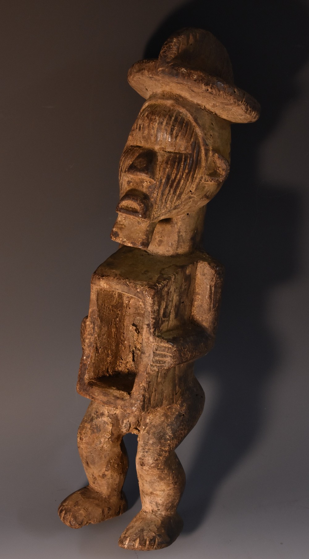 Tribal Art - a Nkysi fetish or power figure, standing, his arms flanking a niche at his waist,