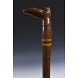 A novelty gentleman's walking cane, the handle carved as a shoe, exotic timber shaft,