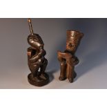 Tribal Art - an African figural pipe, carved as a seated tribesman smoking,