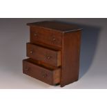 A late 19th century mahogany miniature chest, oversailing top above three long drawers,