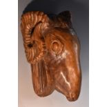 A 19th century Anglo-Indian hardwood wall boss, boldly carved as ram's head, 31cm high, c.