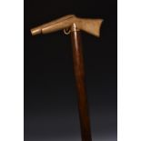 A 19th century novelty gentleman's walking cane, the horn handle carved as a sporting gun,