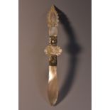 A mother of pearl letter knife, shaped, carved and pierced haft, 17.
