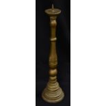 A 18th century giltwood floor standing pricket candlestick, domed sconce, turned column,