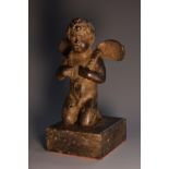 Continental School (19th century), a dark patinated bronze, of a putto, kneeling,