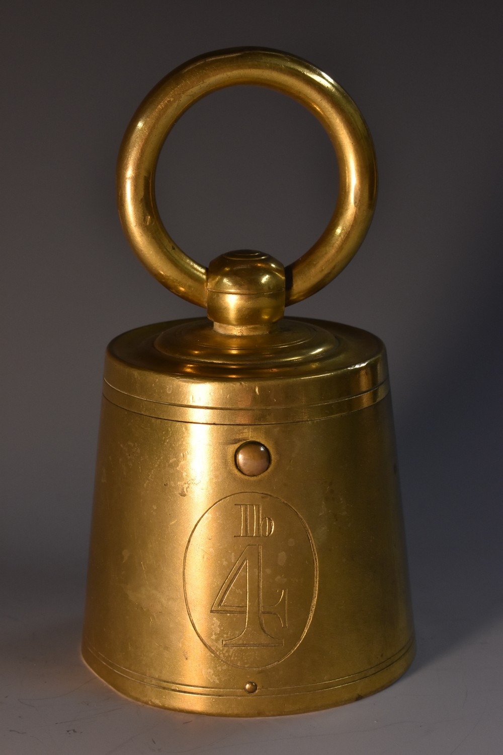 A 19th century gilt brass novelty inkwell, as a 4lb weight, hinged cover, loose ring handle,