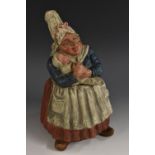 A Continental terracotta novelty tobacco jar and cover, modelled as Dutch wet nurse and baby, 26.