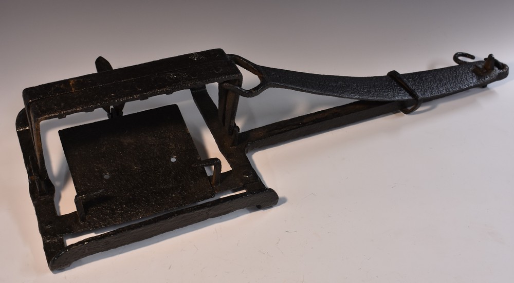 A 19th century iron gamekeeper's estate man trap, rectangular jaws, long setting spring,