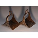 A pair of Islamic Ottoman iron horse stirrups, silver damascened flowerhead and foliate scrolls,