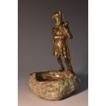 A 19th century bronzed figure, of a Highland soldier, he stands, in traditional uniform,