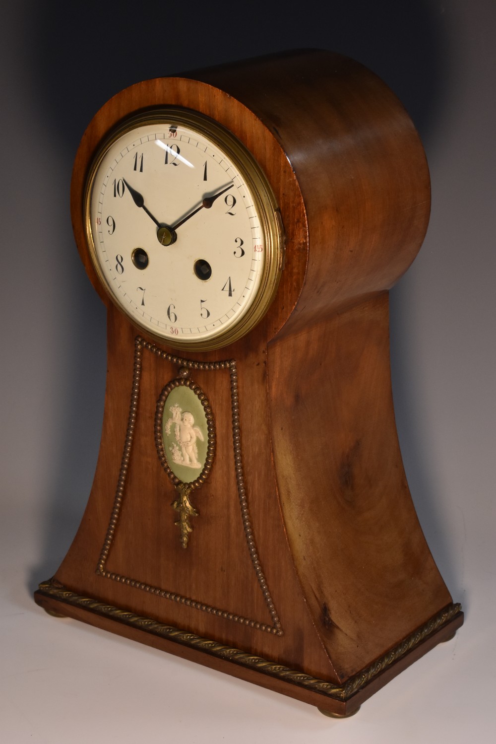 An Edwardian jasperware mounted mahogany ballon shaped mantel clock, 10.