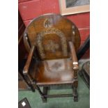 A carved oak shield back hall chair