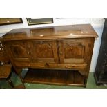 A rustic oak sideboard, oversailing moulded top,