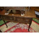 A George III oak side table, rectangular oversailing top, two deep drawers, brass swing handles,