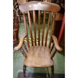 An elm lath back chair, curved top rail, outswept arms, turned supports,