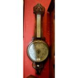 An Edwardian oak cased aneroid barometer