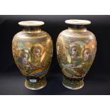 A pair of Japanese Satsuma vases, decorated with immortals,