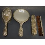 A silver four piece Five Graces dressing table set