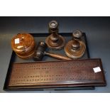 A Georgian mahogany pegboard; gavel; candlesticks;