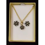 A 9ct gold pendent and earring set, the flower head clusters set with diamond and sapphire chips, 9.