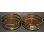 A pair of silver and mahogany wine coasters,