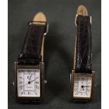 A pair of silver cased wristwatches, rectangular dials,