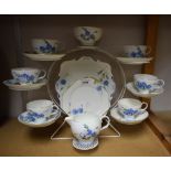 A Paragon tea set for six decorated with blue flowers comprising sandwich plate, cream jug,