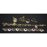 A gold coloured metal charm bracelet; silver bracelet; a yellow metal ring, marked 750,