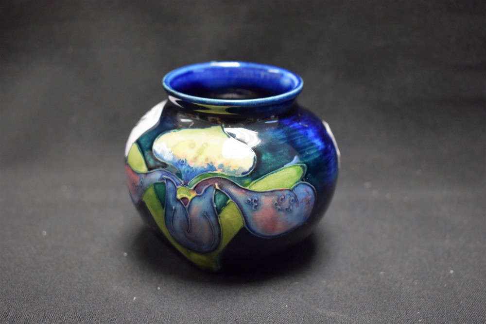 A Moorcroft Iris pattern miniature ovoid vase, in shades of purple,