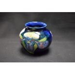 A Moorcroft Iris pattern miniature ovoid vase, in shades of purple,