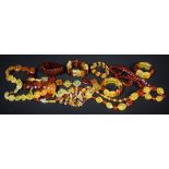 An amber coloured bead necklace other various colours (5) similar bracelets (5) (total 10 items)