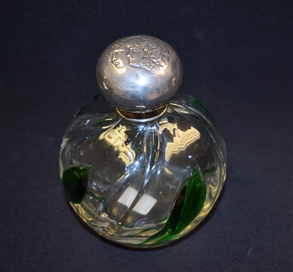 An Edwardian Art Nouveau globular scent bottle, spirally lobed with leafy green inclusions,