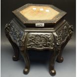 A Chinese padouk wood hexagonal stand, carved with panels of blossoming prunus, 32cm high,