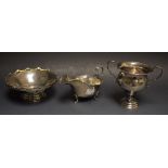 A silver two handled trophy, Birmingham 1932; a silver sauce boat,